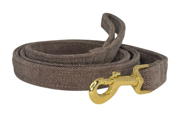 Brown dog leash with a gold clasp on a white background