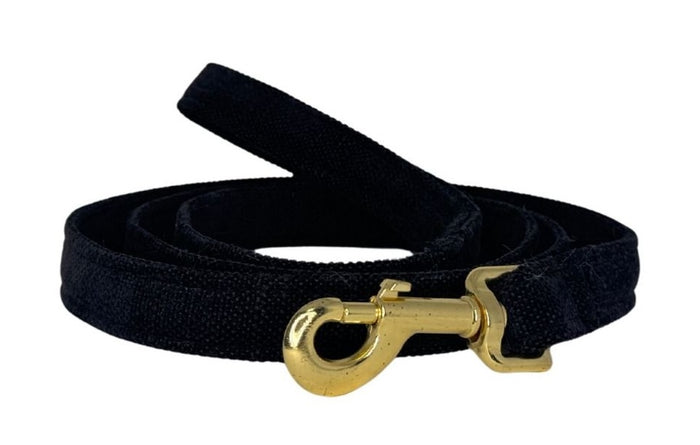 Black dog leash with a gold clasp on a white background