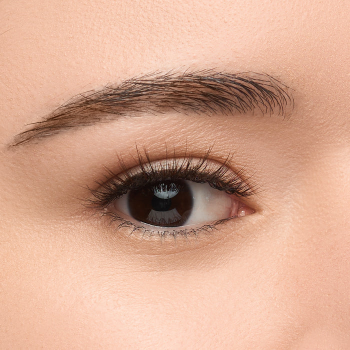 Mocha a short, round lash with natural volume featuring a unique blend of black, brown, and red wine fibers arranged in delicate clusters for natural dimension shown on an eye.