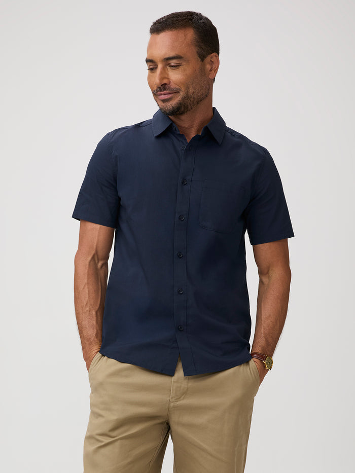 Man wearing a navy blue short-sleeve shirt and khaki pants | 
65% cotton / 30% polyester / 5% spandex
