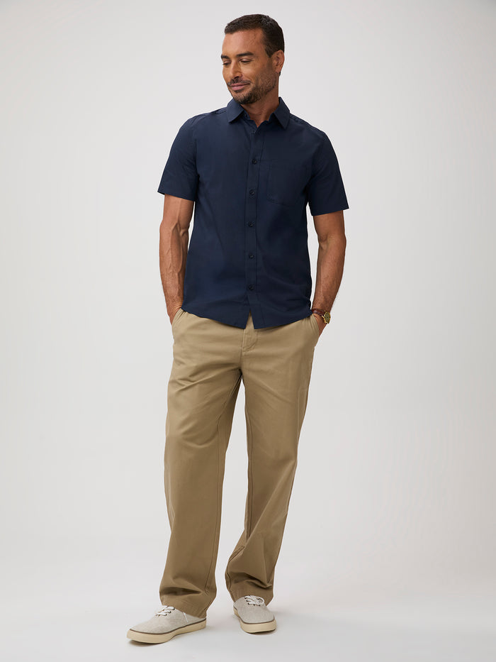 Man wearing a navy shirt and khaki  pants |  stretch fabric, side pleats, forgiving fit, all-day comfort