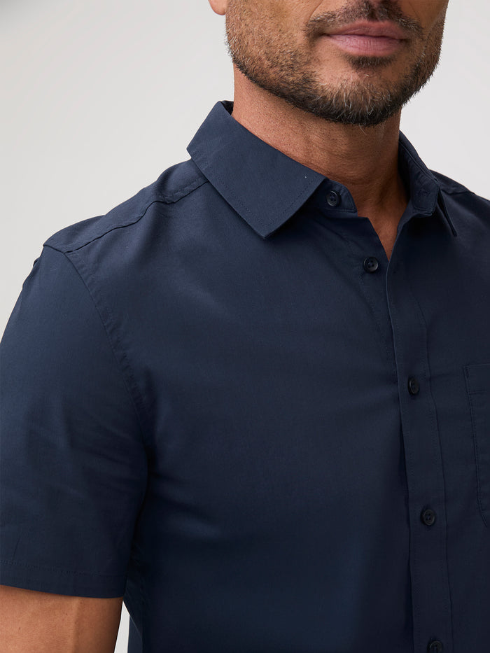 Man wearing a navy blue shirt | shirts forgiving through the shoulders, chest, and midsection