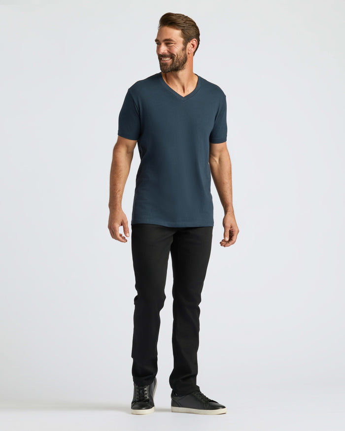 Man wearing Classic V-Neck, slim-fit pants, low-top sneakers.