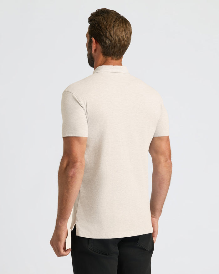 Back view of man wearing Oatmeal Classic Polo, highlighting fit and side vents.