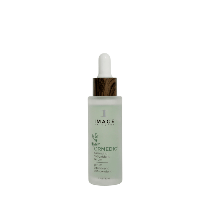 Bottle of ORMEDIC balancing antioxidant serum | IMAGE Skincare with frosted glass and wood-textured dropper cap, designed for skincare and wellness routines.