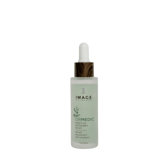 Bottle of ORMEDIC balancing antioxidant serum | IMAGE Skincare with frosted glass and wood-textured dropper cap, designed for skincare and wellness routines.