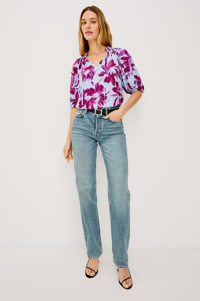 Paris Short-Sleeve Top with Shirred Collar, V-neckline with Ties, Deep Pleats on Sleeves and Elastic at the Sleeve Opening in Blue Lily Colorway, Blues and Pink- Front View Featured on Model