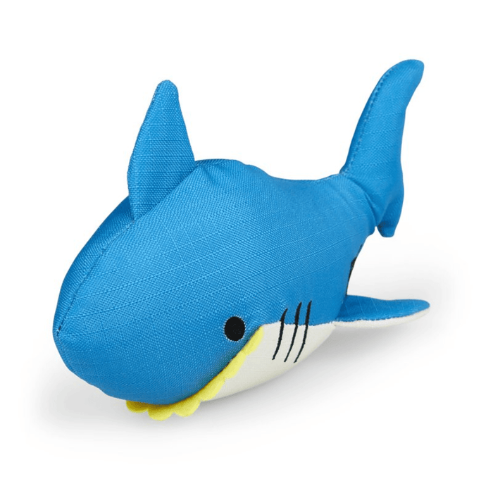 Bright blue plush shark dog toy with a white belly and yellow felt teeth on a white back ground.