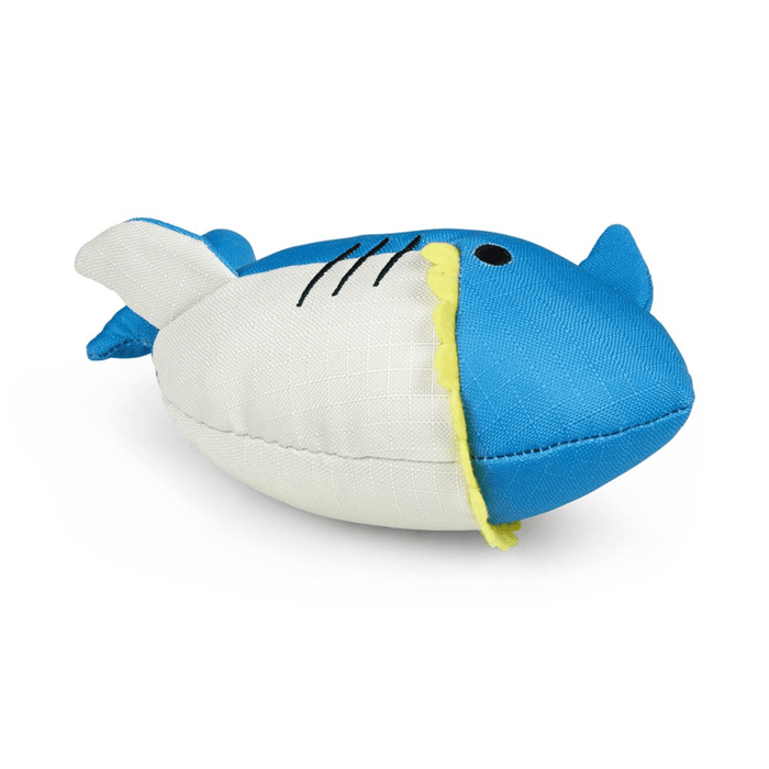 Front view of bright blue plush shark dog toy with a white belly and yellow felt teeth on a white back ground.