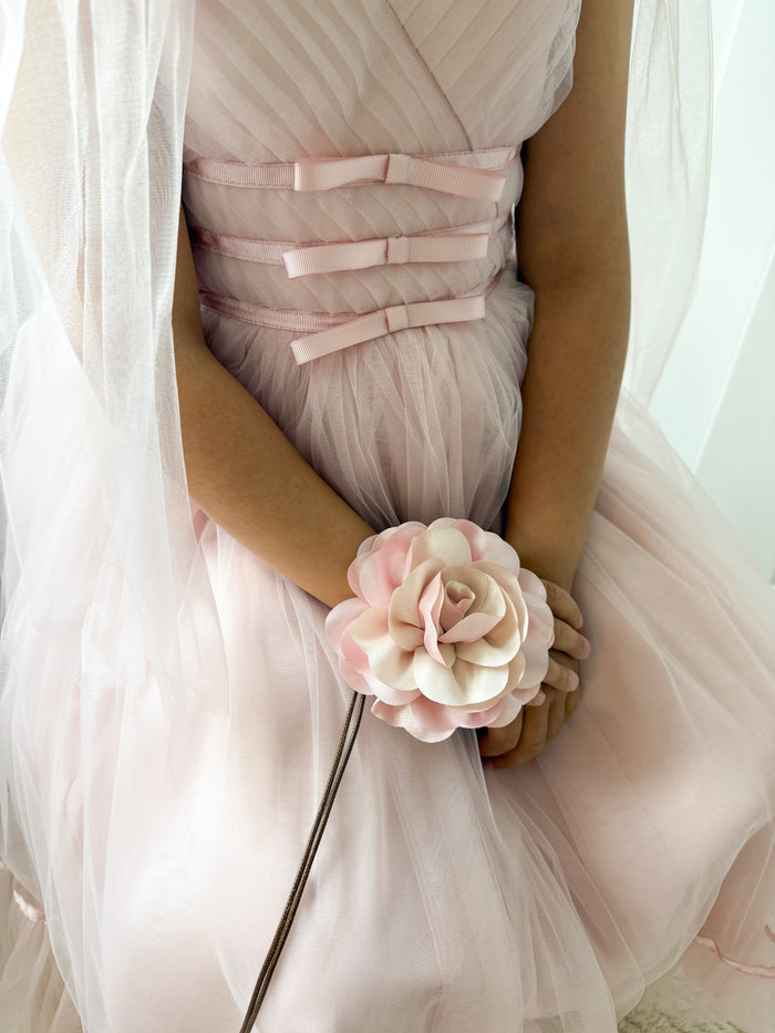 Close up of pink flower neck tie highlighting textured layered fabric rose accessory for girls formal and holiday wear