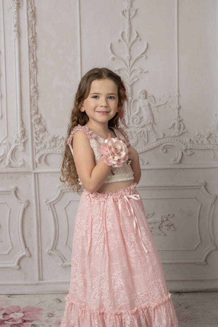 Child wearing pink flower neck tie with a matching top and skirt, highlighting the texture of the fabric rose