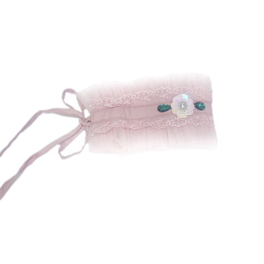 Pink ballerina hair sash featuring soft pleated fabric, lace trim, and decorative jewel accents, styled with a delicate tie back ribbon