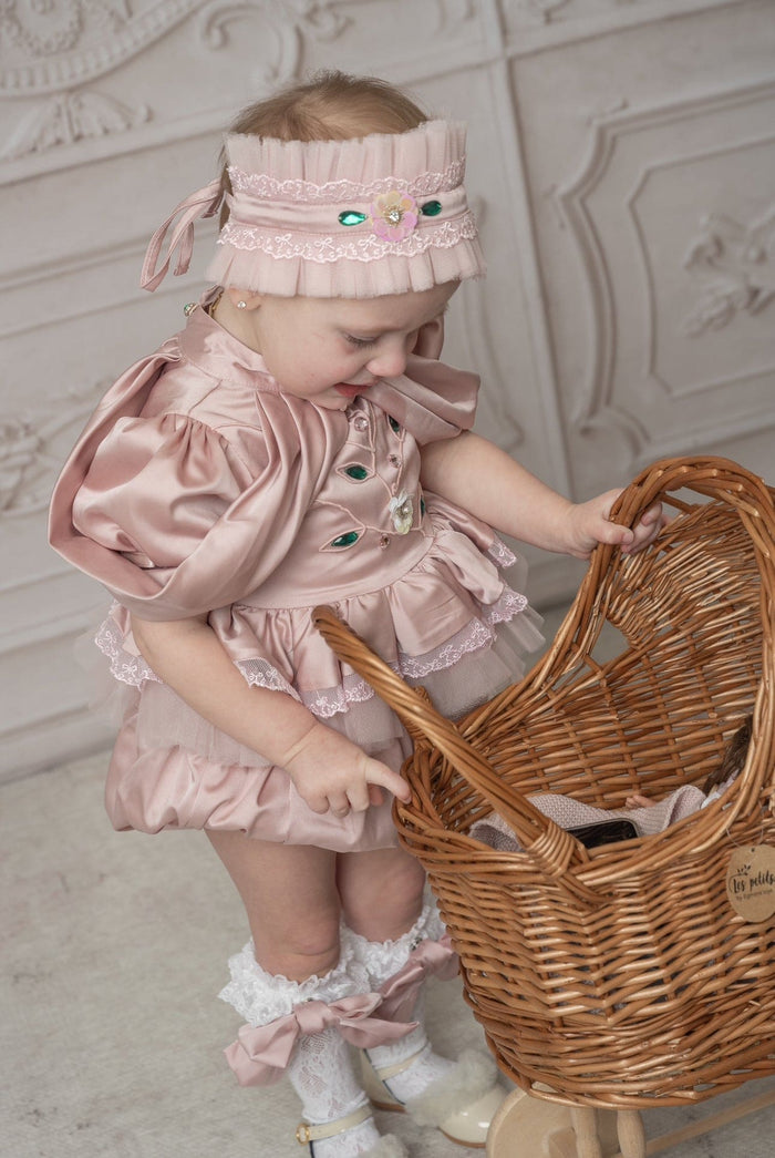 Pink ballerina hair sash with lace trim and jewel embellishments worn by a baby, paired with a pink ballerina outfit for a whimsical photoshoot
