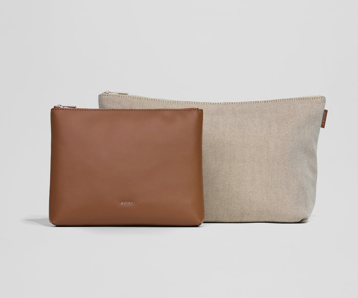 Two pouches, one brown and one beige, on a light gray background