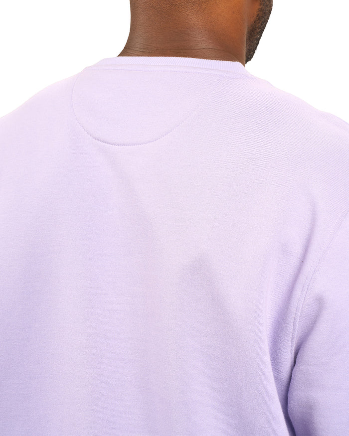 man wearing an light purple colored sweater from Black Clover with a 3d text BLCK CLVR on the chest