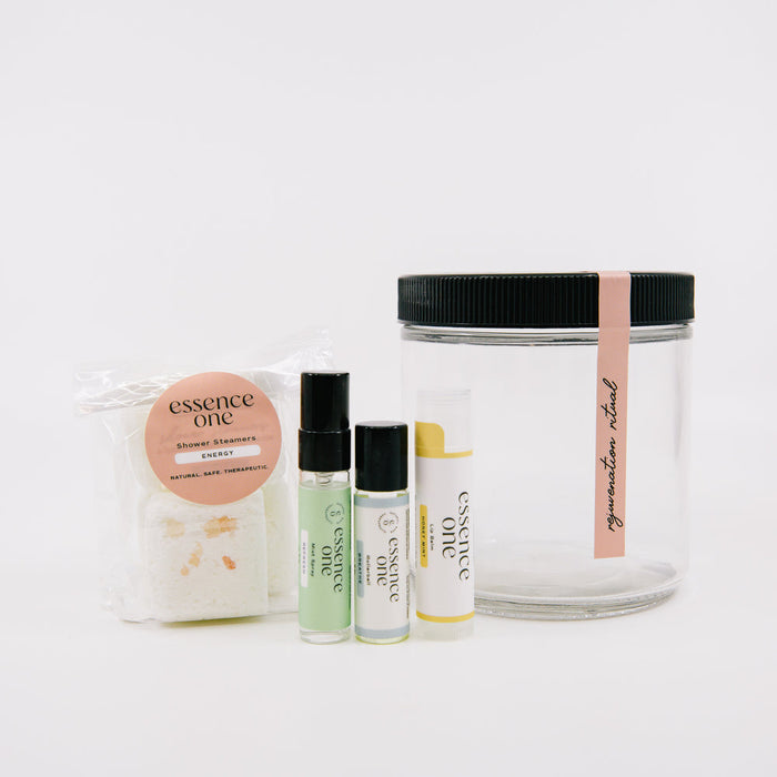 Clear jar with black lid and pink label alongside skincare and body care items including shower steamers and wellness sprays from the Ritual Kit | Essence One collection by Live Love Spa