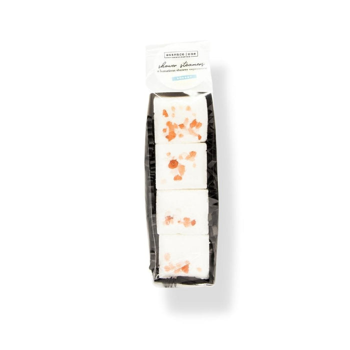 Packaged set of four white Shower Steamer | Essence One cubes with orange speckles on top, designed for a refreshing and aromatic wellness shower experience.