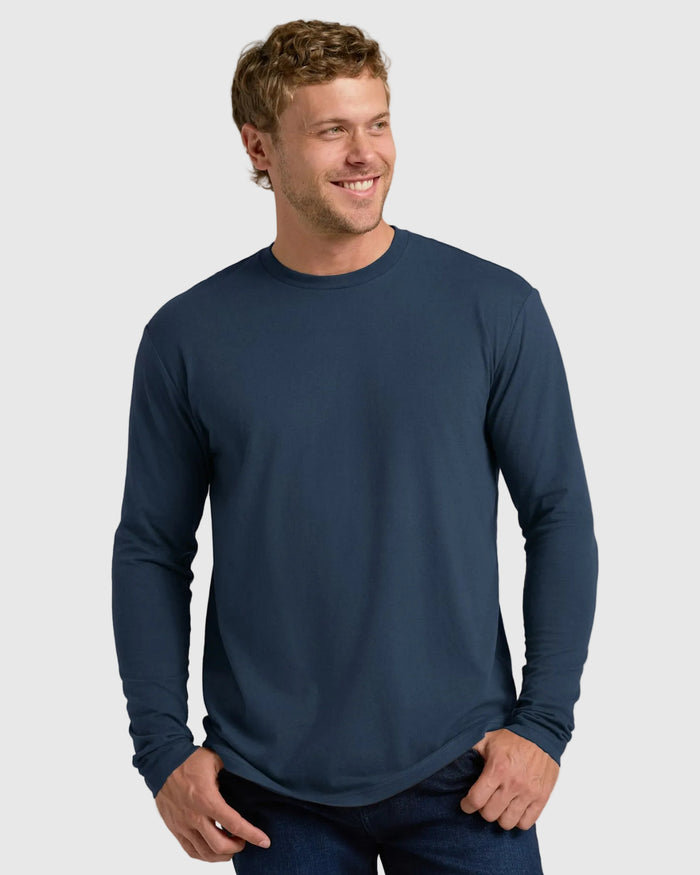 Man wearing Staple Classic Long Sleeve Crew Neck in navy, smiling casually.