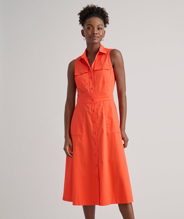 Model is wearing UNTUCKit Codelia dress in solid orange.