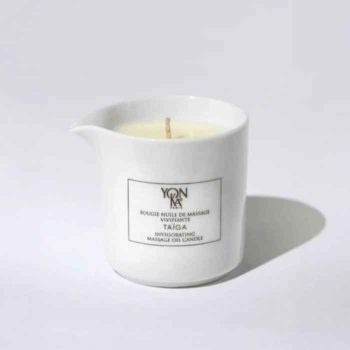 Taiga Massage Candle | Yon-Ka Paris in a white ceramic container with a wick, designed for skincare and body care wellness rituals.