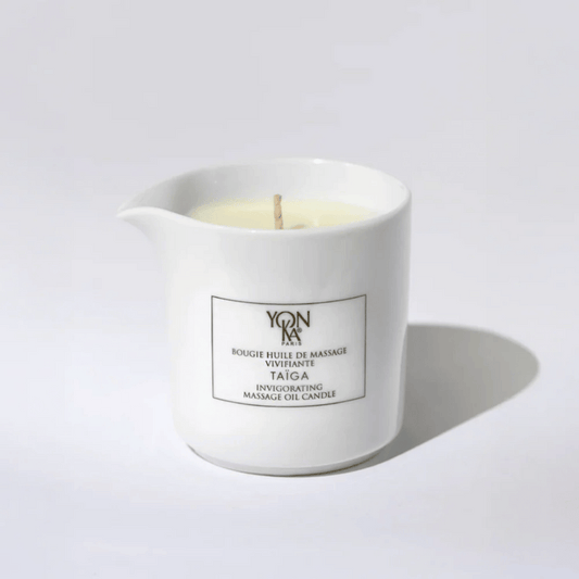 Taiga Massage Candle | Yon-Ka Paris in a white ceramic container with a wick, designed for skincare and body care wellness rituals.