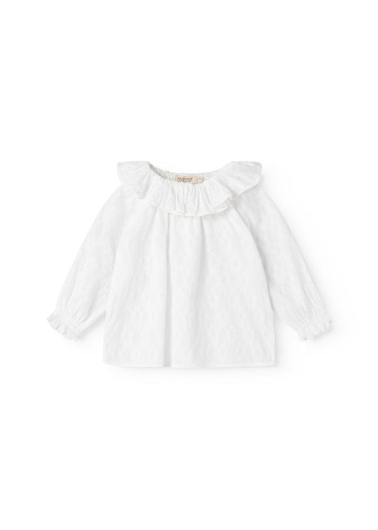 White baby blouse with a V-neck collar, long sleeves, and a lightly pleated fall.