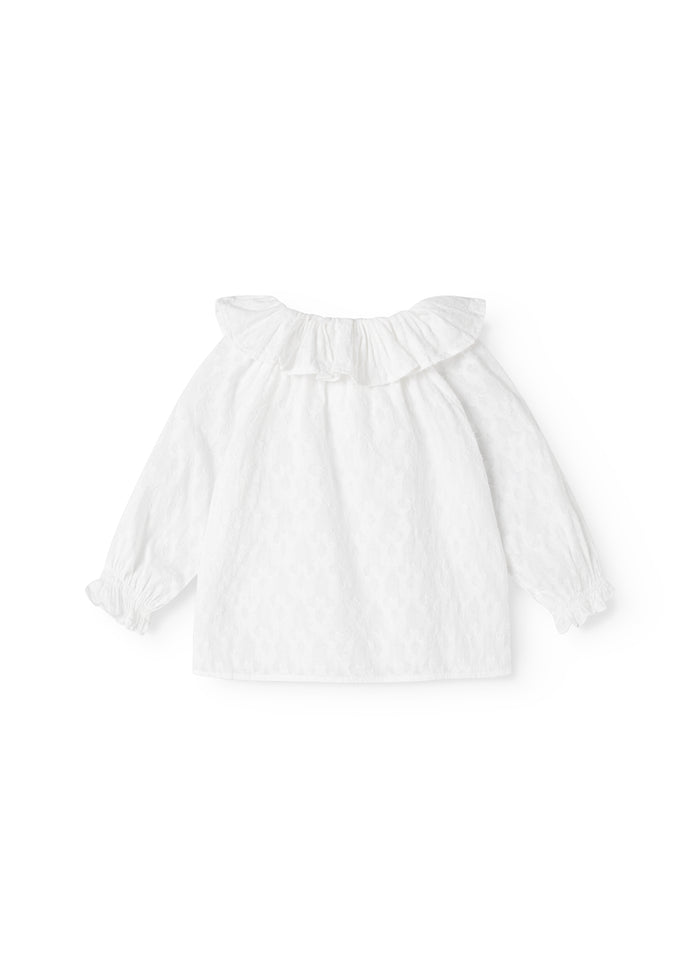 White baby blouse with a V-neck collar and ruffled sleeves, loose fit.