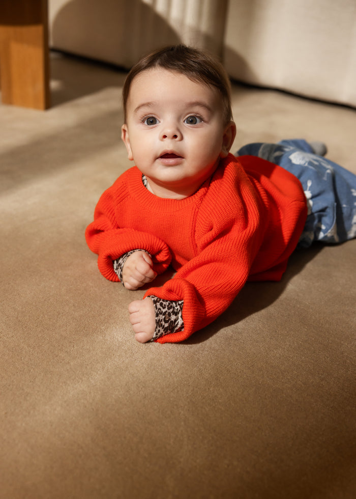 Torin B orange striped blouse for baby, round neck and ribbed edges on sleeves.