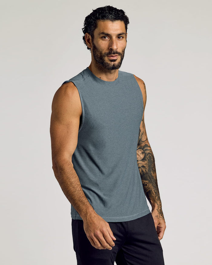 Man wearing a heather navy Sleeveless Active Muscle Tee 3-Pack, showcasing a sleeveless, fitted muscle tee in a soft, breathable fabric for men's active basics.