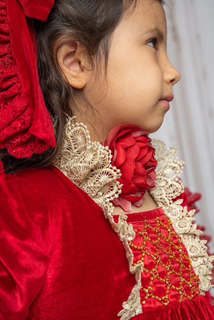 Side view of Victoria red flower neck tie worn by child, showcasing dimensional red fabric rose and vintage inspired holiday styling