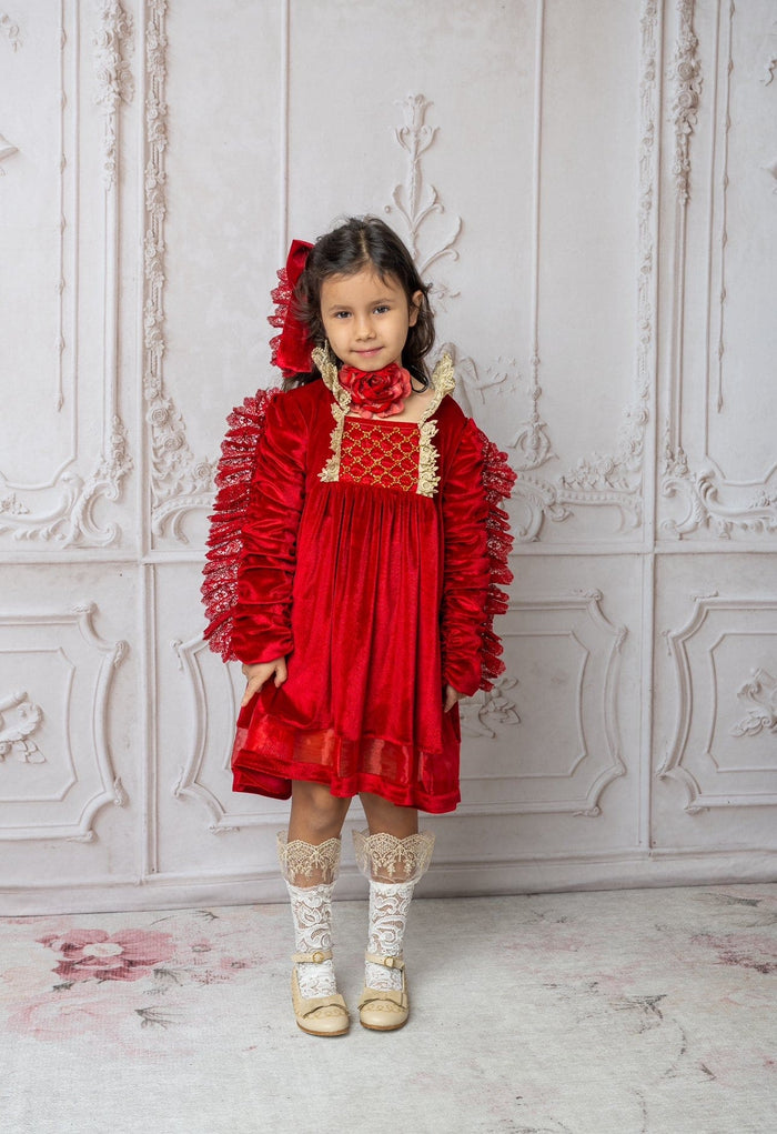 Full outfit view of child wearing Victoria red flower neck tie with red velvet dress, creating a timeless holiday look