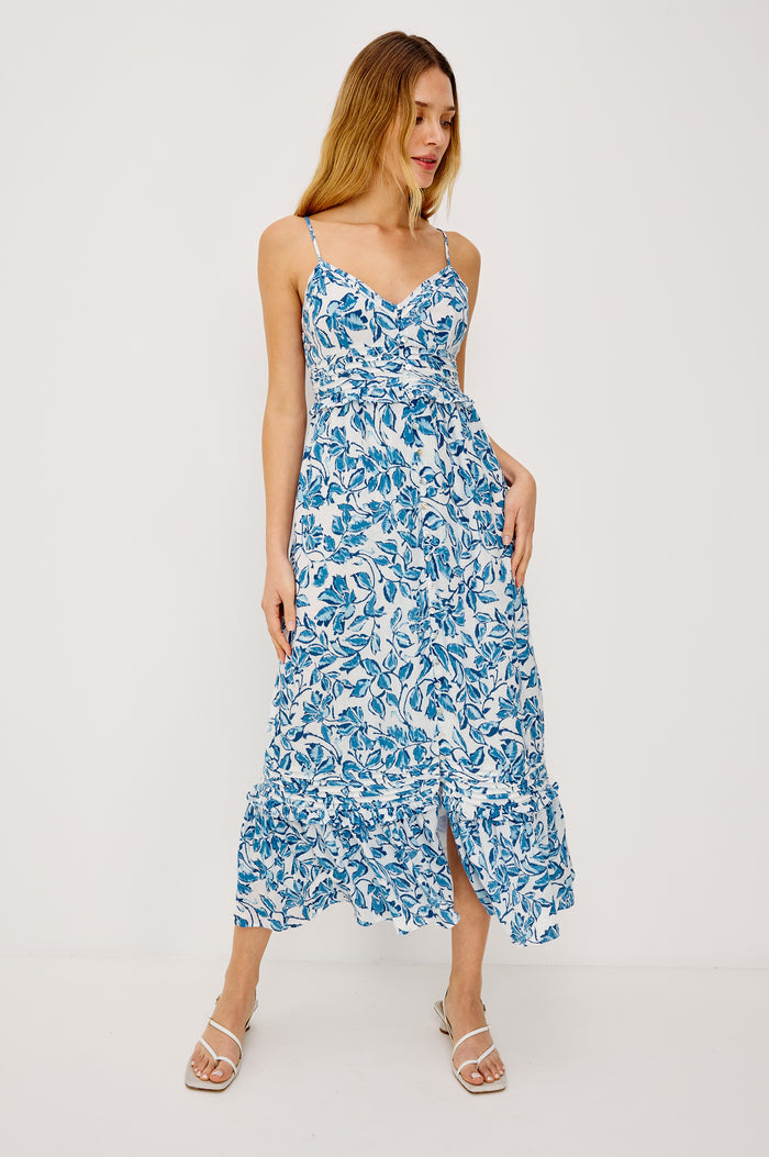 Wisteria Midi Dress in Luxe Linen With V-Neckline, Adjustable Shoulder Straps, Front Buttons, Seam and Ruffle Detailing, Relaxed Fit, and Smocked Back in Azure Jasmine Colorway - Full Body Front View Featured on Model