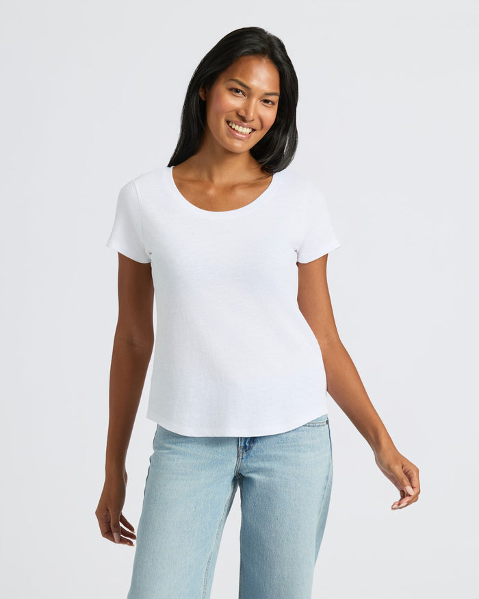 Woman in White Slub Scoop Neck Tee and Light Jeans. MODEL_INFO: Candy is 5'9", wearing a size S
