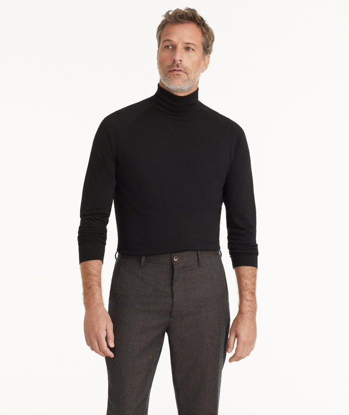 Model is wearing UNTUCKit Hilburn turtleneck in black.